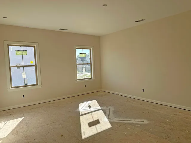 a view of room with hardwood floor and window