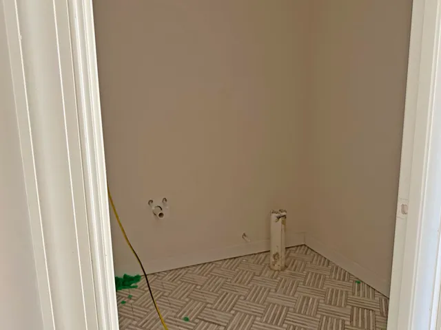 a view of an empty room and a window