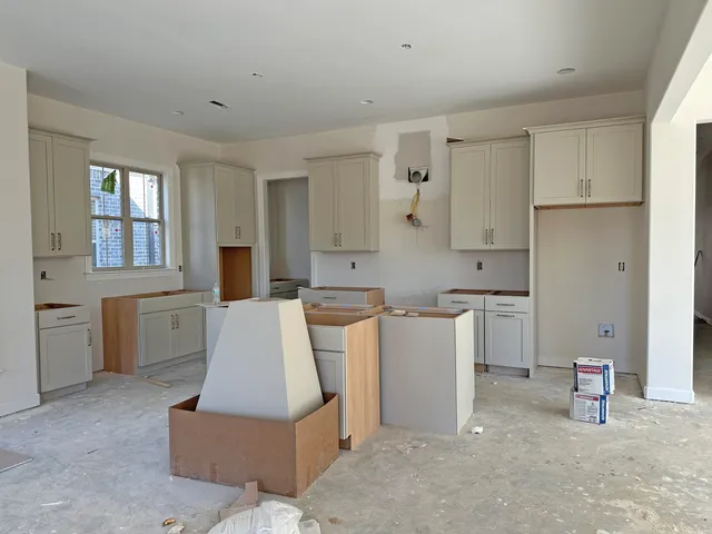 a kitchen with cabinets and refrigerator