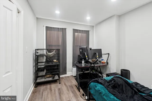 a view of a workspace with furniture and wooden floor
