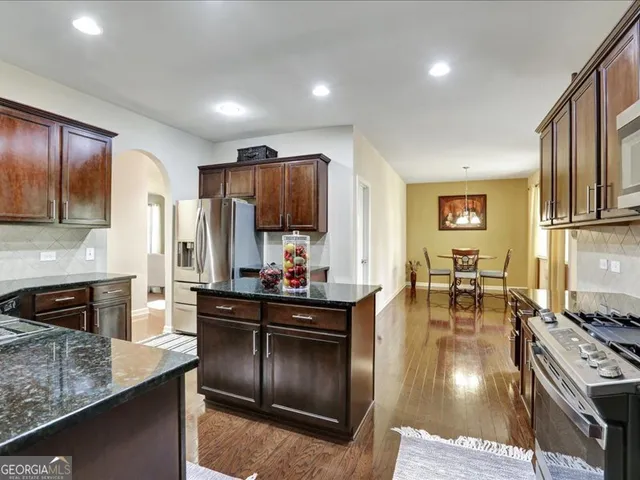 a kitchen with lots of counter top space and stainless steel appliances