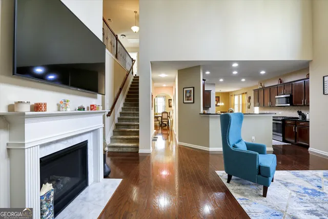 a living room with furniture a flat screen tv and a fireplace
