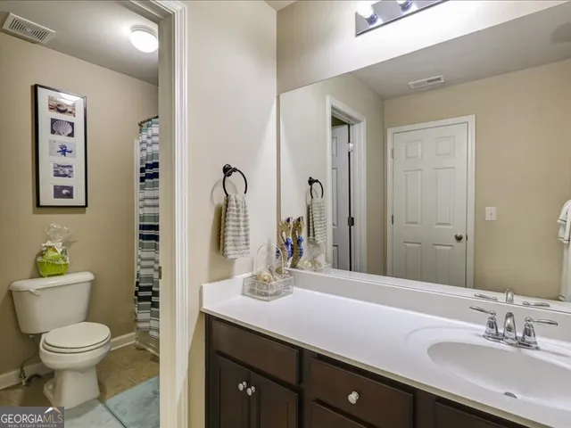 an empty room with a ceiling fan and a window