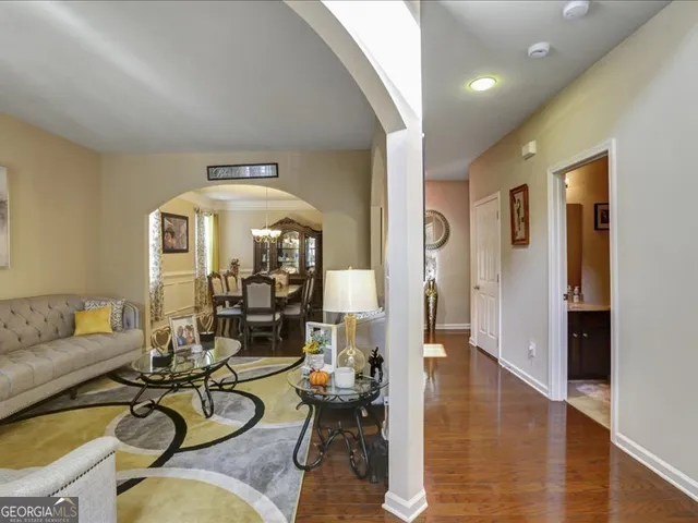 a living room with fireplace furniture and wooden floor