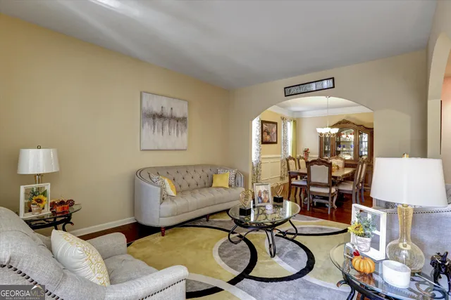 a living room with furniture and wooden floor