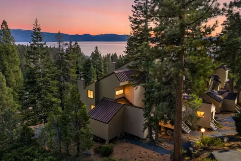a view of a chairs and table in backyard