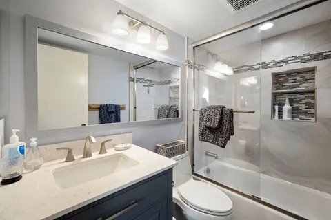 a spacious bedroom with a bed and wooden floor