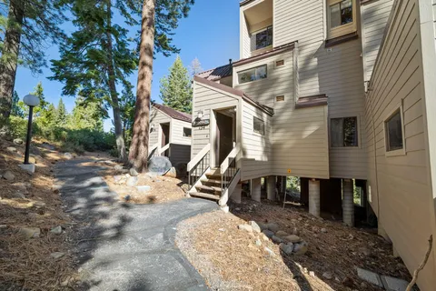 a aerial view of a house with a yard and sitting area