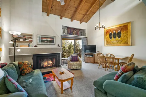 a living room with furniture fireplace and a window