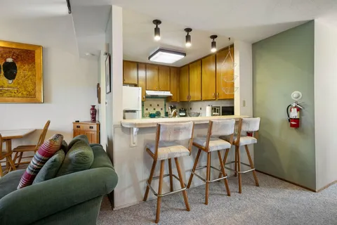 a kitchen with stainless steel appliances granite countertop a sink a stove and cabinets