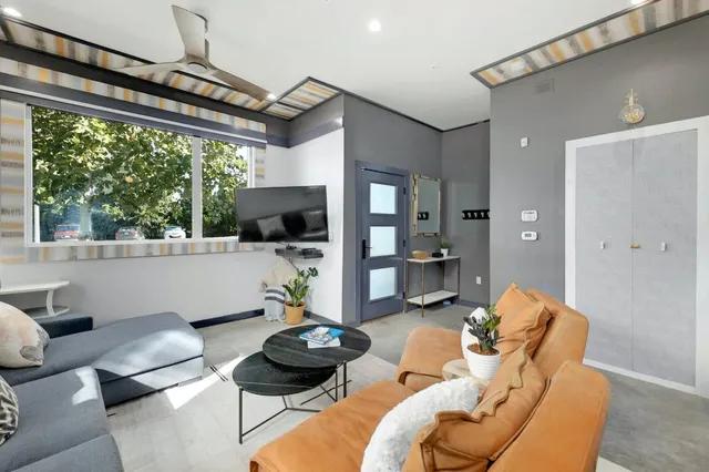 a living room with furniture and a floor to ceiling window