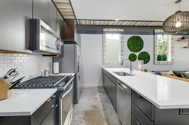 a kitchen with a sink stove and cabinets