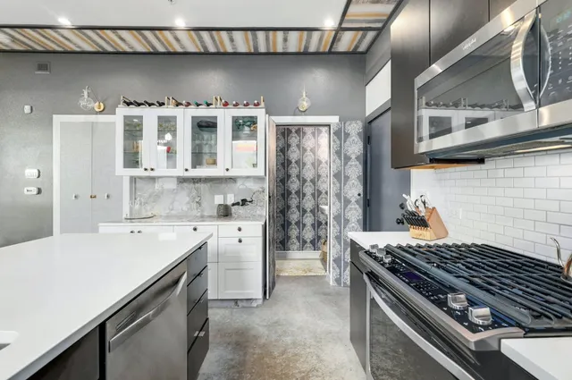 a kitchen with a stove and a white refrigerator