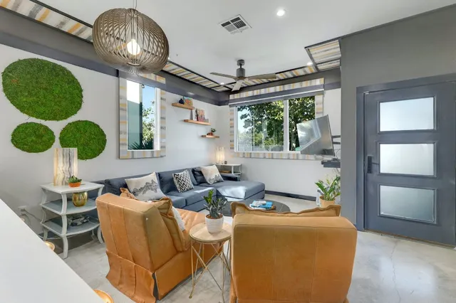 a living room with fireplace furniture and a chandelier