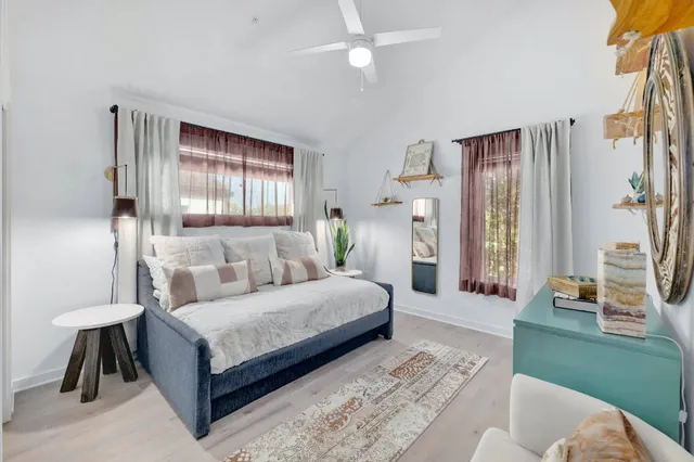 a bedroom with a bed couch and a window