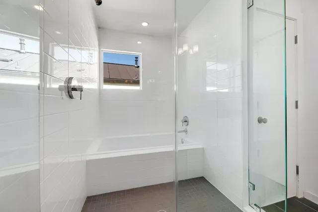 a bathroom with a bathtub and shower