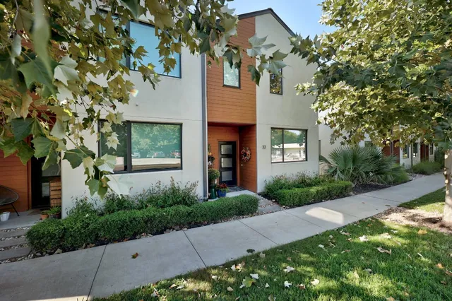 a front view of a house with a garden