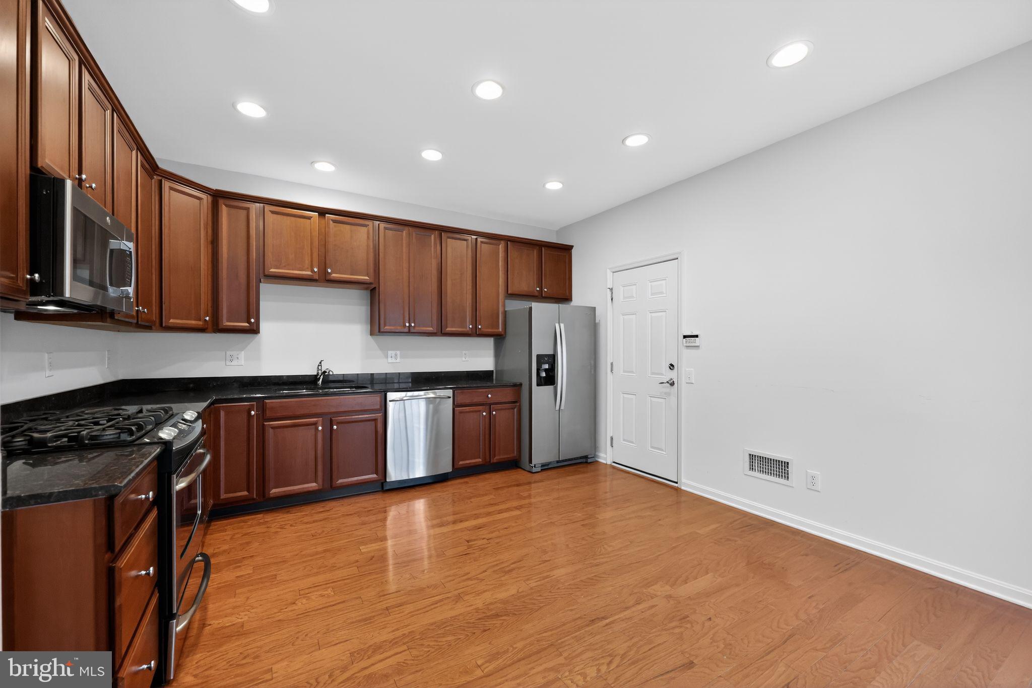 27 Stokes Avenue Voorhees, NJ 08043 - Photo 11 of 39 a kitchen with stainless steel appliances granite countertop a stove a sink and a refrigerator