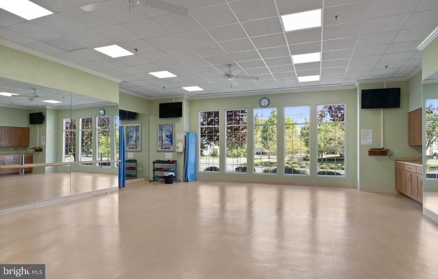 27 Stokes Avenue Voorhees, NJ 08043 - Photo 32 of 39 a view of a hall with wooden floor and floor to ceiling window
