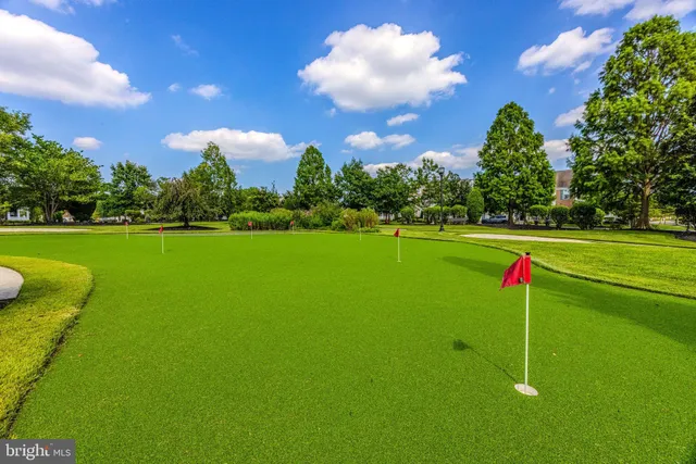 a room with pool table and windows