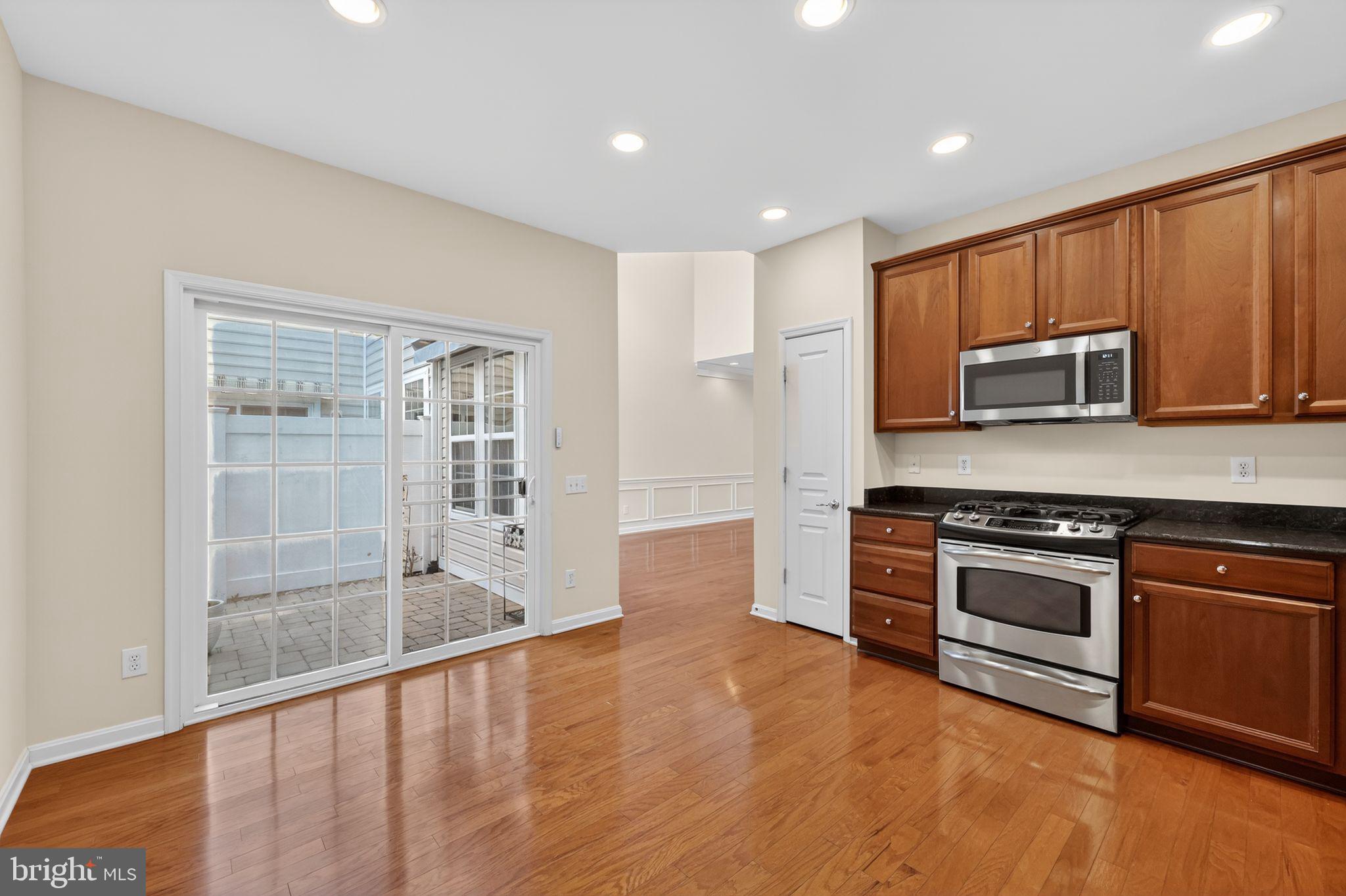27 Stokes Avenue Voorhees, NJ 08043 - Photo 10 of 39 a kitchen with stainless steel appliances granite countertop a stove a sink and a microwave