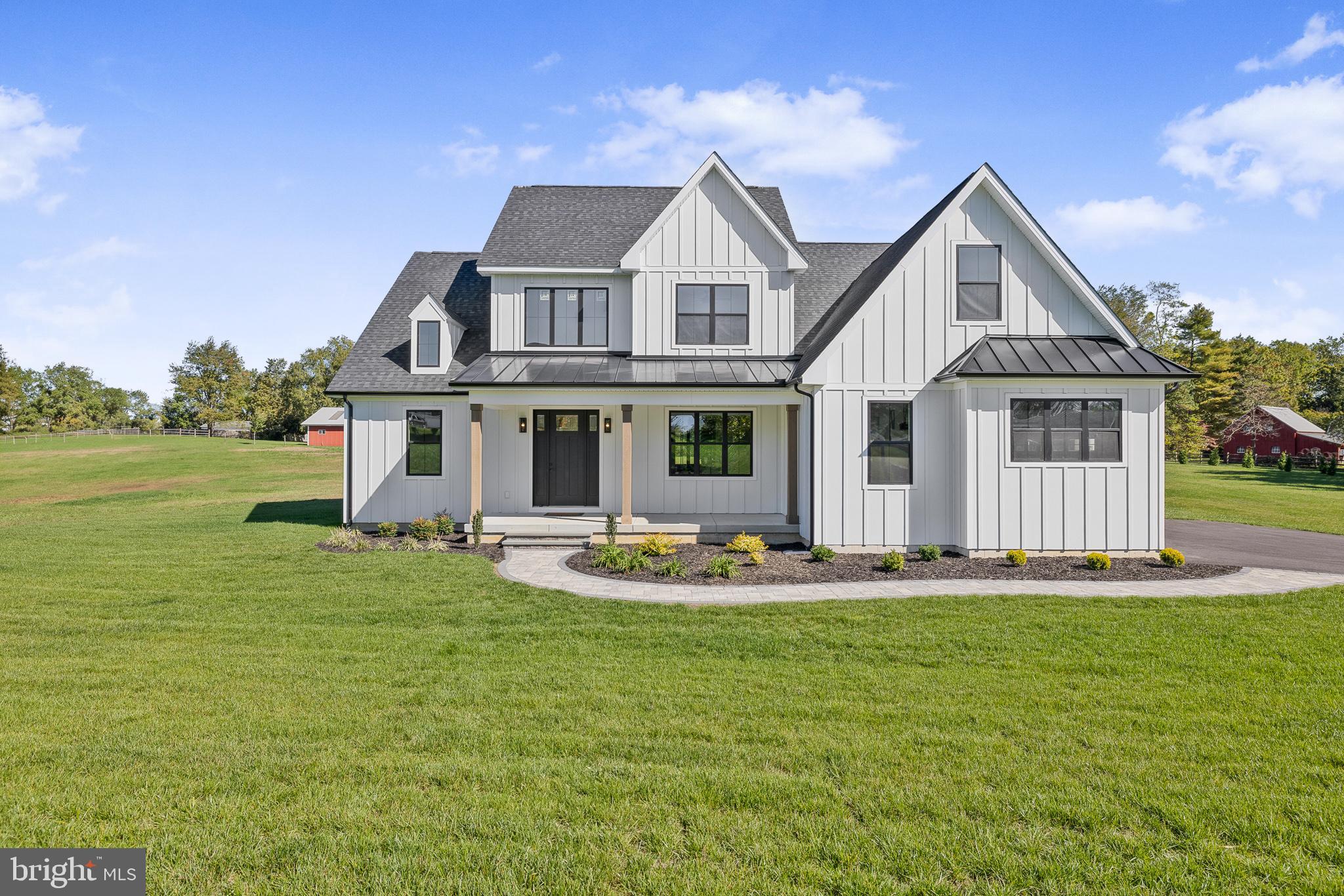 415 Marcus Road Townsend, DE 19734 - Photo 103 of 115 a front view of a house with a garden and porch