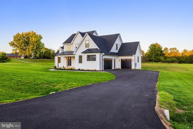 a kitchen with stainless steel appliances granite countertop a sink window and cabinets