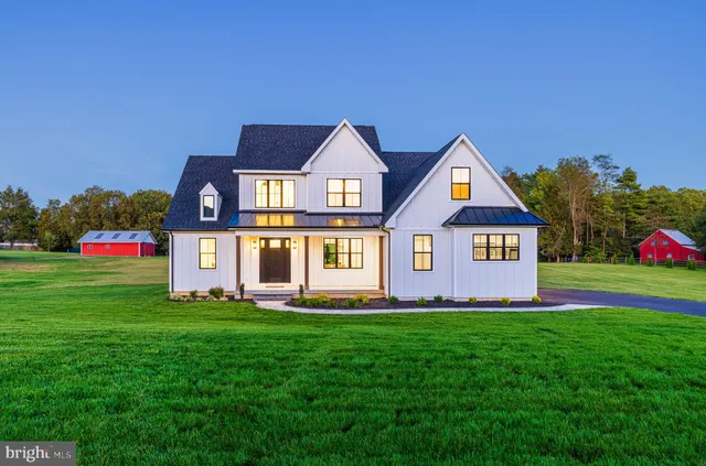 a kitchen with stainless steel appliances granite countertop white cabinets a refrigerator and a sink