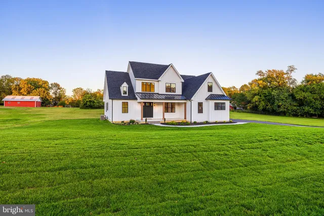 a dining room with furniture a chandelier and wooden floor