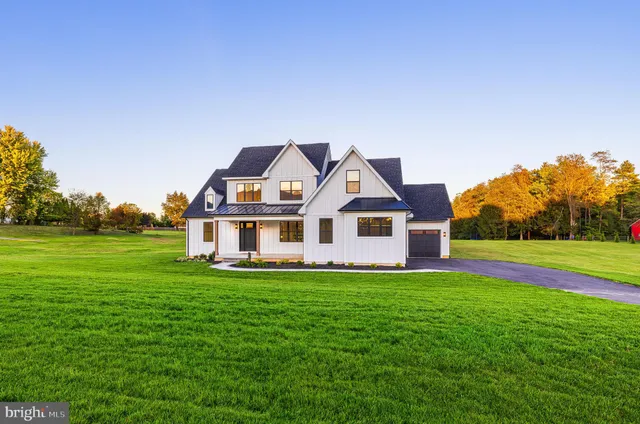 a front view of a house with a yard table and chairs