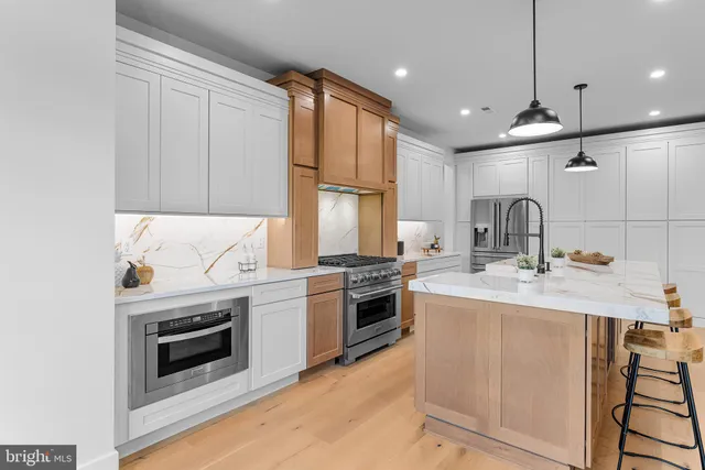a spacious bedroom with a bed and a chandelier