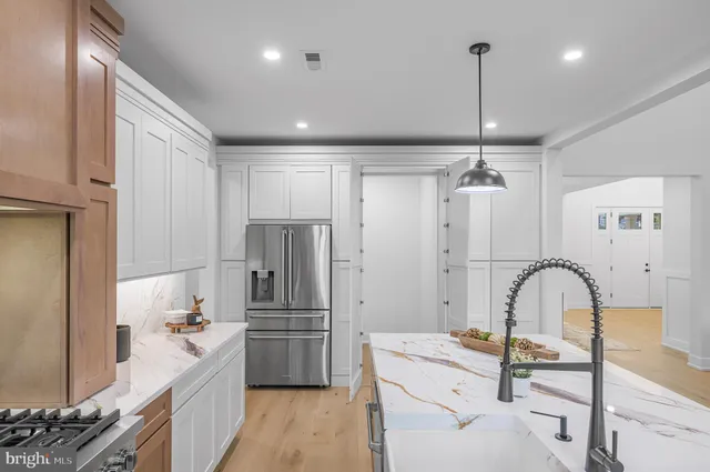 an empty room with a ceiling fan and window