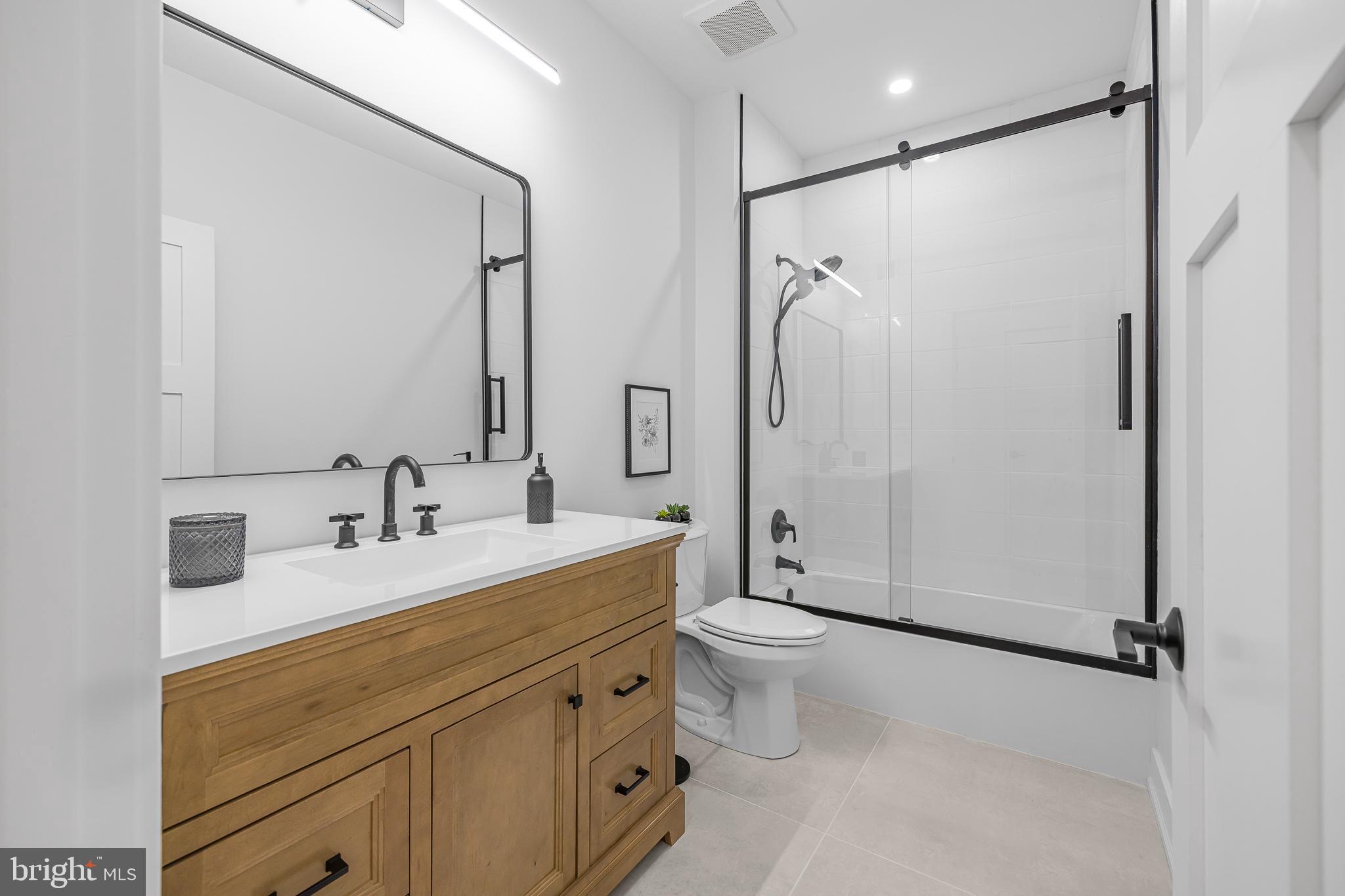 415 Marcus Road Townsend, DE 19734 - Photo 84 of 115 a bathroom with a double vanity sink toilet mirror and shower