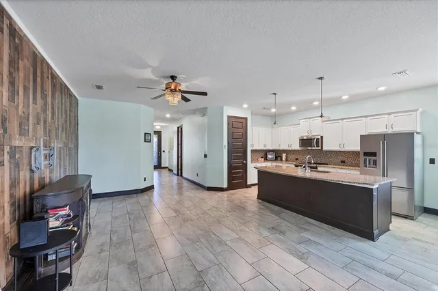 a view of a room with a table chairs and windows