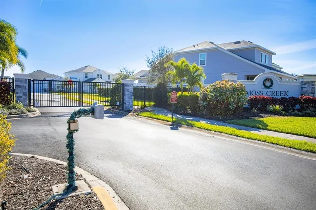 a view of a street with potted plants
