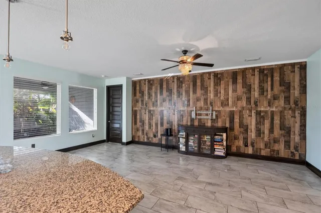 a view of a kitchen with furniture and wooden floor