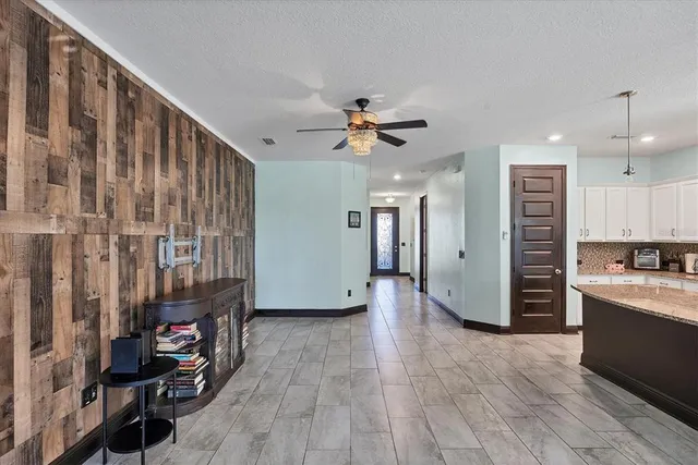 a view of kitchen with stainless steel appliances kitchen island granite countertop a refrigerator and a stove top oven