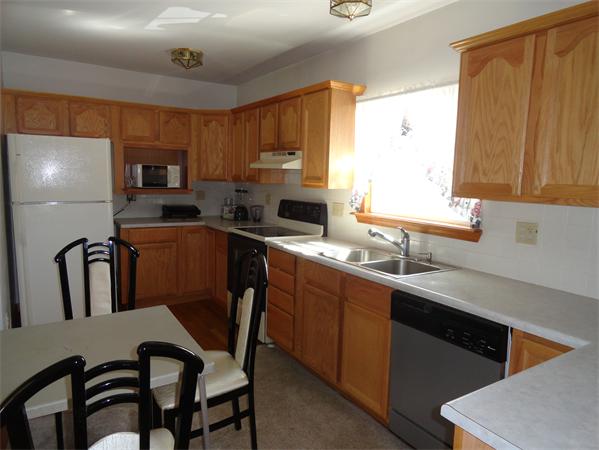 659 Cambridge Street Fall River, MA 02721 - Photo 7 of 18 a kitchen with stainless steel appliances a sink cabinets and a dining table