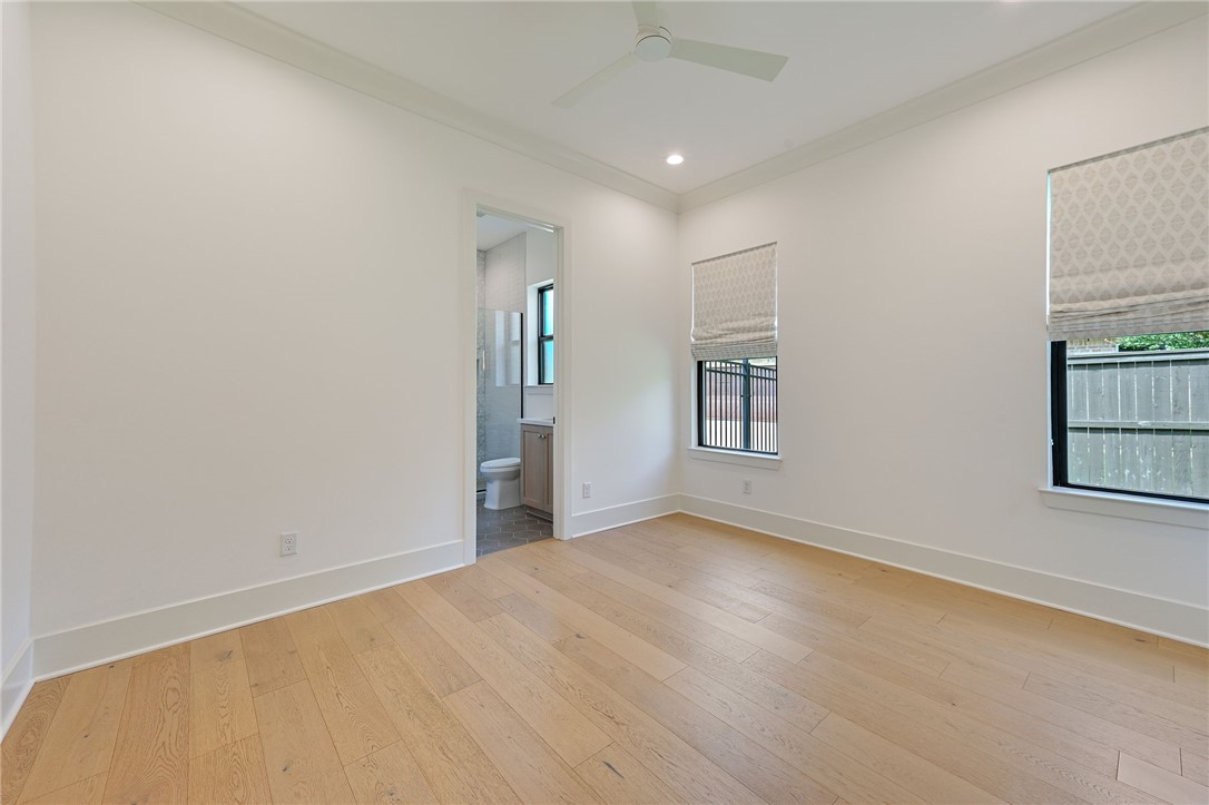 5115 Inverness Drive Bryan, TX 77802 - Photo 18 of 28 Bedroom featuring light wood finished flooring, a window, and a ceiling fan