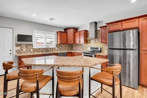 a large kitchen with a table and chairs