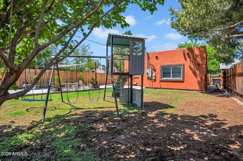 a view of backyard with outdoor seating and green space