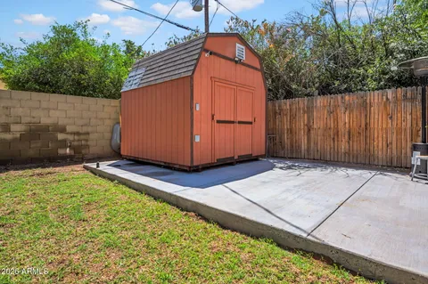 a view of a backyard with sitting area and tree s