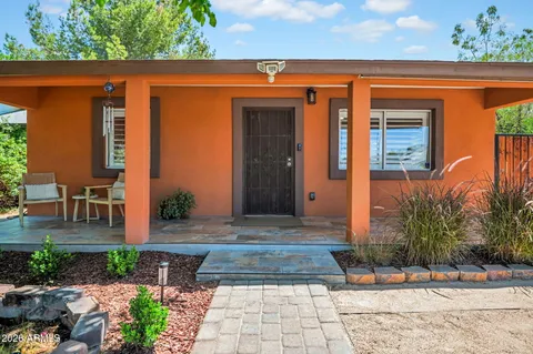 a backyard of a house with table and chairs