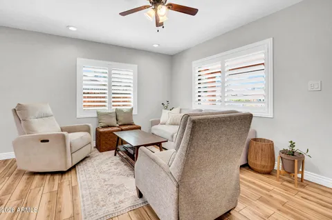 a living room with furniture and a mirror