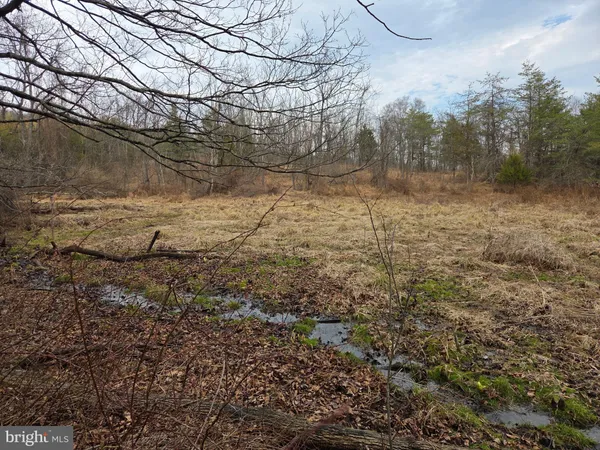 front view of a house with a chairs and table in the patio