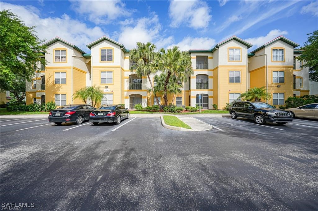 11490 Villa Grand, Unit 224 Fort Myers, FL 33913 - Photo 1 of 30 a view of a city street lined with parked cars