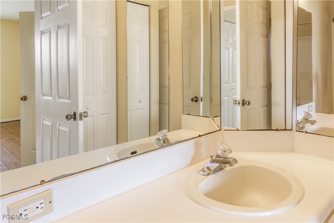 11490 Villa Grand, Unit 224 Fort Myers, FL 33913 - Photo 11 of 30 a bathroom with a sink and a mirror