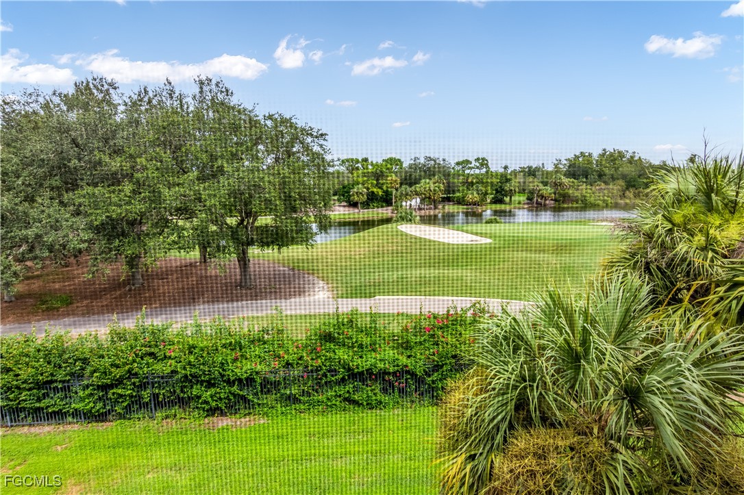 11490 Villa Grand, Unit 224 Fort Myers, FL 33913 - Photo 18 of 30 a view of a lake with a yard