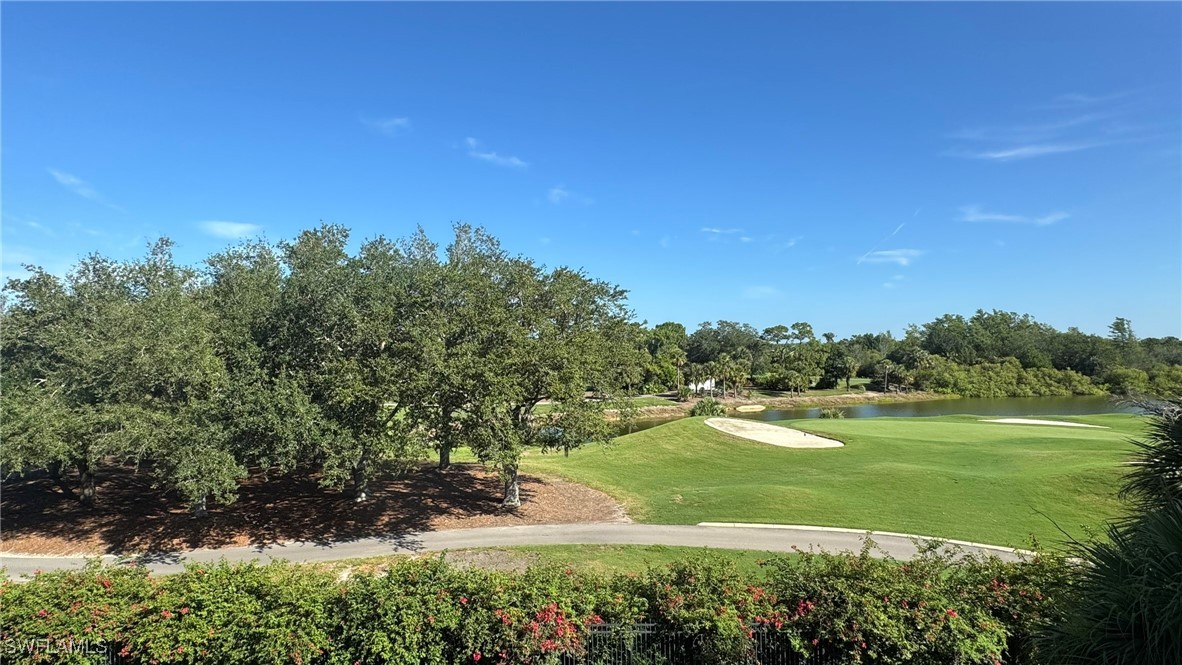 11490 Villa Grand, Unit 224 Fort Myers, FL 33913 - Photo 19 of 30 a view of a big yard with a large tree and plants