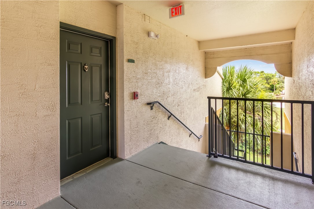 11490 Villa Grand, Unit 224 Fort Myers, FL 33913 - Photo 23 of 30 an entryway with a door and wooden floor